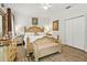 Inviting bedroom with classic wood furniture, complemented by hardwood floors and bright lighting at 14131 Paradise Tree Dr, Orlando, FL 32828