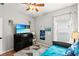 Bright bedroom with a comfy bed, soft lighting, TV and window; a peaceful retreat for rest and relaxation at 14131 Paradise Tree Dr, Orlando, FL 32828