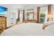 Bright bedroom boasts a spacious layout, stylish decor, and a tranquil ambiance with a tropical view on the TV at 14131 Paradise Tree Dr, Orlando, FL 32828