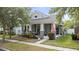 Charming gray single-Gathering home featuring a covered front porch, manicured landscaping and an American flag at 14131 Paradise Tree Dr, Orlando, FL 32828
