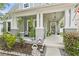 Inviting front porch with hanging plants, cozy seating and decorative accents creating a relaxing outdoor space at 14131 Paradise Tree Dr, Orlando, FL 32828