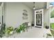 Covered front porch featuring stylish decor, including a welcome sign, bench seating, and decorative plants at 14131 Paradise Tree Dr, Orlando, FL 32828