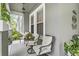 Inviting front porch with cozy seating, a neutral rug and decorative plants providing a relaxing outdoor space at 14131 Paradise Tree Dr, Orlando, FL 32828
