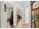 Hallway displays an open layout connecting to adjacent rooms, hardwood and tile flooring, and natural light at 14131 Paradise Tree Dr, Orlando, FL 32828