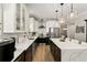 Stylish kitchen with black and white cabinetry, marble countertops, and stainless steel appliances at 14131 Paradise Tree Dr, Orlando, FL 32828