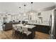Open-concept kitchen with a center island, stainless steel appliances, and hardwood flooring at 14131 Paradise Tree Dr, Orlando, FL 32828