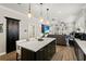 Open floor plan with kitchen island, stainless appliances, and seamless flow to living area at 14131 Paradise Tree Dr, Orlando, FL 32828