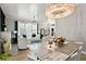 Bright living room with elegant chandelier, white furniture, and decor at 14131 Paradise Tree Dr, Orlando, FL 32828