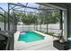 Inviting screened-in pool area, complete with patio furniture and lush landscaping, perfect for outdoor enjoyment at 14131 Paradise Tree Dr, Orlando, FL 32828