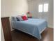 Cozy bedroom featuring a comfortable bed with blue bedding and a shuttered window at 1474 Thornhill Cir, Oviedo, FL 32765