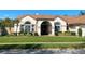 Charming home featuring a well-manicured lawn and decorative shrubbery at 1474 Thornhill Cir, Oviedo, FL 32765
