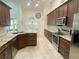 This kitchen has updated stainless appliances, granite countertops, and beautiful dark wood cabinets at 1474 Thornhill Cir, Oviedo, FL 32765
