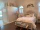 A charming primary bedroom features a large bed, detailed ceilings and shuttered windows for light control at 1474 Thornhill Cir, Oviedo, FL 32765