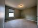 A carpeted bedroom is finished in neutral paint and features a modern window shade at 15157 Pigeon Plum Ln, Winter Garden, FL 34787