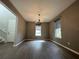 Elegant dining room with wood floors, chandelier, and natural light from large windows at 15157 Pigeon Plum Ln, Winter Garden, FL 34787