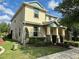 Charming two-story home featuring stone accents, a covered porch, and well-manicured landscaping at 15157 Pigeon Plum Ln, Winter Garden, FL 34787