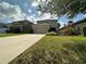 Well-maintained two-story home with a spacious driveway and lush green lawn at 15157 Pigeon Plum Ln, Winter Garden, FL 34787