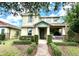 Charming two-story home featuring a covered porch, lush landscaping, and a welcoming entrance at 15157 Pigeon Plum Ln, Winter Garden, FL 34787