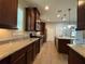 Gourmet kitchen boasting stainless steel appliances, granite counters, and dark wood cabinetry at 15157 Pigeon Plum Ln, Winter Garden, FL 34787