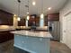 Spacious kitchen featuring granite countertops, stainless steel appliances, and ample cabinet space at 15157 Pigeon Plum Ln, Winter Garden, FL 34787