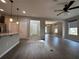 Open-concept living room with wood floors, neutral paint, and seamless flow to dining and kitchen at 15157 Pigeon Plum Ln, Winter Garden, FL 34787