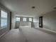 Spacious loft area with plush carpeting, natural light, and white railing at 15157 Pigeon Plum Ln, Winter Garden, FL 34787