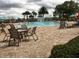 Resort-style community pool with water features, lounge chairs, and tables at 15157 Pigeon Plum Ln, Winter Garden, FL 34787