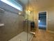 Glass shower with tile surround, and view of the dual vanity bathroom at 15157 Pigeon Plum Ln, Winter Garden, FL 34787