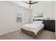 Comfortable bedroom with carpet flooring, a ceiling fan, and a large window letting in natural light at 16892 Hypatia Aly, Winter Garden, FL 34787