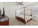 A bedroom with a four poster bed, ceiling fan, dresser and natural light at 16892 Hypatia Aly, Winter Garden, FL 34787