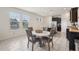 Bright dining area with tile floors adjacent to kitchen, featuring large windows offering plenty of natural light at 16892 Hypatia Aly, Winter Garden, FL 34787