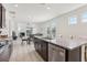 Spacious open-concept kitchen flowing into the dining and living areas, featuring stainless steel appliances and granite countertops at 16892 Hypatia Aly, Winter Garden, FL 34787