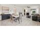 Inviting living area with modern furniture, a dining table, and tile flooring, perfect for entertaining guests at 16892 Hypatia Aly, Winter Garden, FL 34787