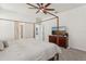 Bedroom with a wooden four poster bed, ceiling fan and adjacent ensuite bathroom at 16892 Hypatia Aly, Winter Garden, FL 34787