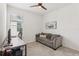 Bright office featuring a ceiling fan, comfortable couch, and wooden desk by the window at 16892 Hypatia Aly, Winter Garden, FL 34787