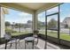 Inviting screened patio with brick flooring provides a cozy outdoor living space with neighborhood views at 16892 Hypatia Aly, Winter Garden, FL 34787