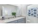 Bright bathroom featuring a double sink vanity with granite countertops and neutral paint at 186 Amberwood Way, Umatilla, FL 32784
