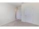 Neutral bedroom featuring beige carpet, baseboards, and white doors at 186 Amberwood Way, Umatilla, FL 32784