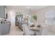 Bright, open-concept kitchen featuring a dining area with a round table and white chairs at 186 Amberwood Way, Umatilla, FL 32784