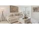 Cozy living room with neutral tones, textured wall art, and a decorative floor lamp at 186 Amberwood Way, Umatilla, FL 32784