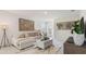 Inviting living room featuring a comfortable sofa, decorative rug, and stylish wall art at 186 Amberwood Way, Umatilla, FL 32784