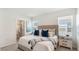 Cozy bedroom with a soft bed, bedside tables, and an attached closet for ample storage at 186 Amberwood Way, Umatilla, FL 32784