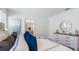 Inviting main bedroom with a dresser, decorative mirror, and comfortable bed with accent pillows at 186 Amberwood Way, Umatilla, FL 32784