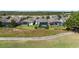 Aerial view of several homes with screened-in pools overlooking a golf course with ponds and lush landscaping at 1925 Estuary Ln, Kissimmee, FL 34747