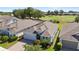 Beautiful aerial view of the home, showcasing the well-manicured lawn, lush landscaping, and golf course views at 1925 Estuary Ln, Kissimmee, FL 34747
