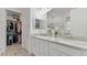 Bright bathroom features double sinks with granite countertops and a spacious walk-in closet at 1925 Estuary Ln, Kissimmee, FL 34747
