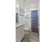 Cozy bathroom features a shower and tub combination, single sink, and wood look tile floors at 1925 Estuary Ln, Kissimmee, FL 34747
