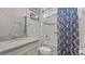 Bright bathroom features a shower and tub, granite countertop, and decorative Coastal wall hangings at 1925 Estuary Ln, Kissimmee, FL 34747