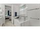Bright bathroom features a tub with glass shower doors leading to bedroom at 1925 Estuary Ln, Kissimmee, FL 34747