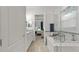 Bright bathroom features a tub with glass shower doors leading to bedroom at 1925 Estuary Ln, Kissimmee, FL 34747